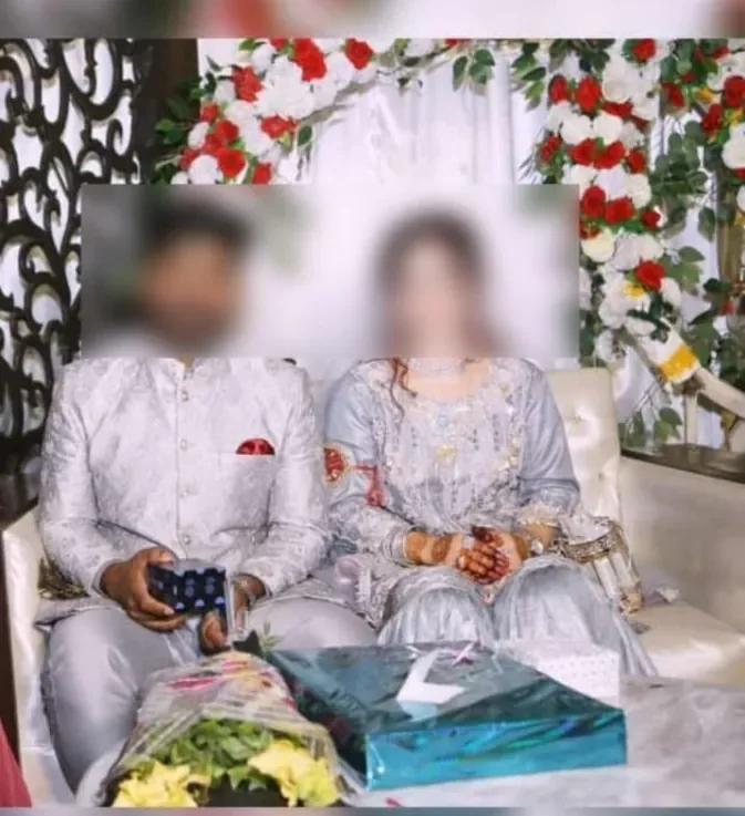 Couple on their Walima reception stage with gifts and floral decor