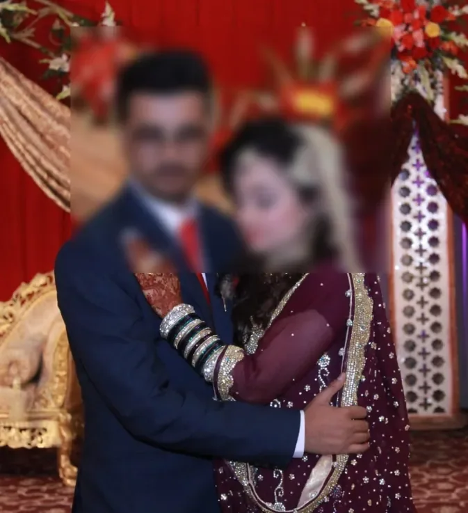 Newly married couple posing together at their wedding reception stage