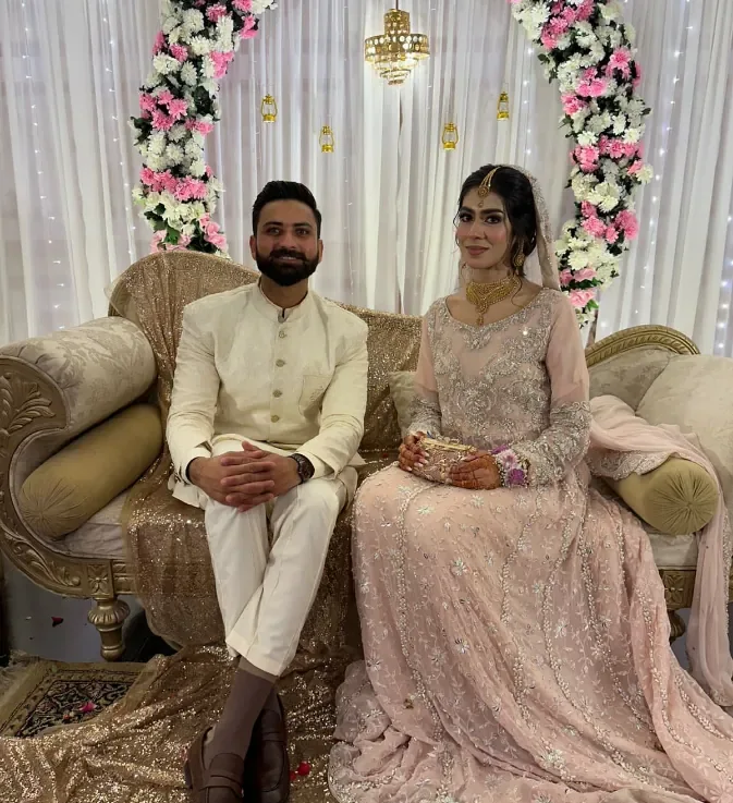 Couple seated gracefully on stage during their Nikkah reception